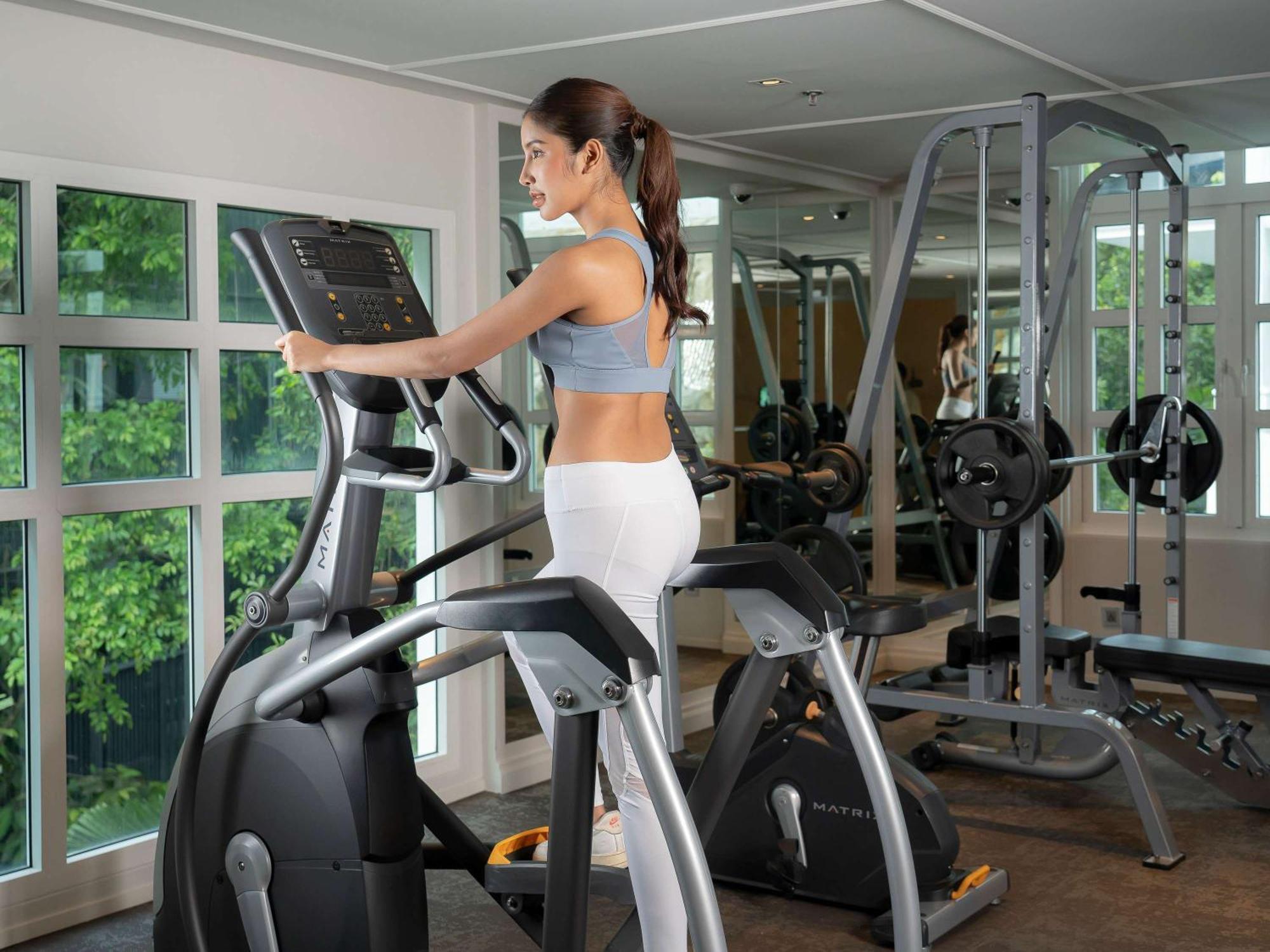 Moevenpick Myth Hotel Patong Phuket Esterno foto A woman on a cross trainer